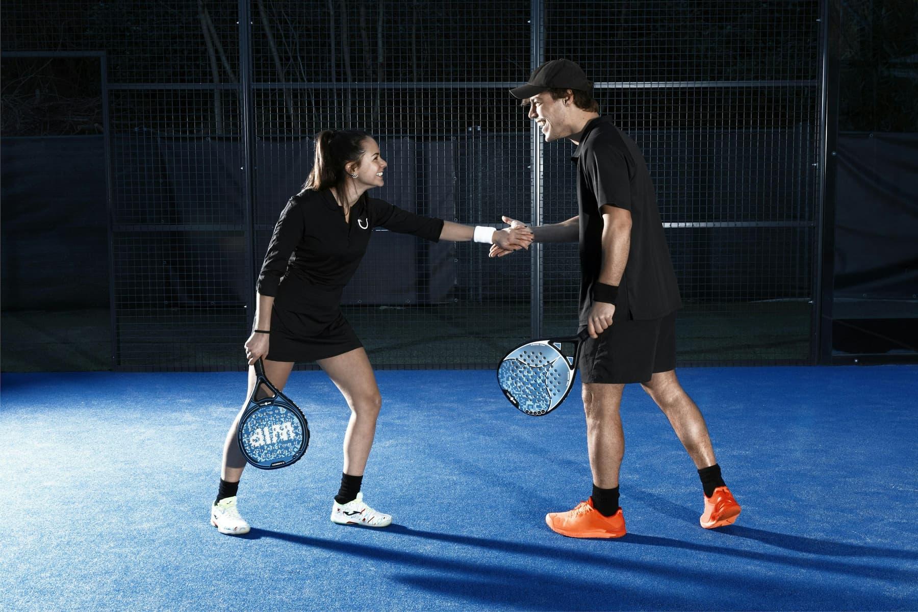 Two players shaking hands on court after a match